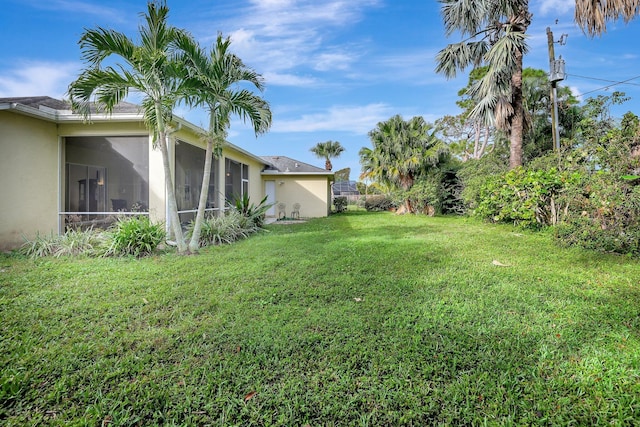 view of yard featuring a sunroom