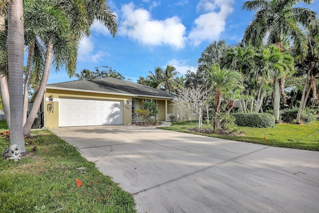 single story home featuring a garage and a front lawn