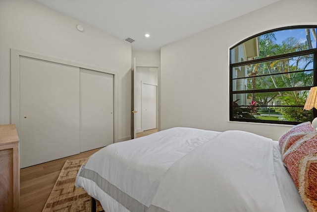 bedroom with a closet and light hardwood / wood-style floors