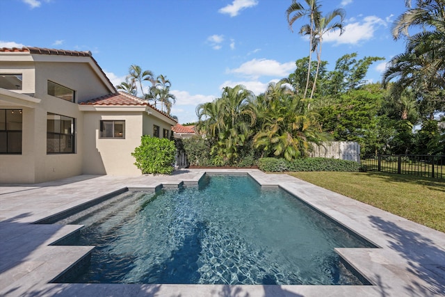 view of swimming pool featuring a lawn