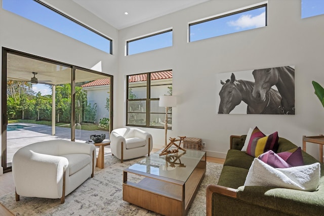 living room featuring light wood-type flooring, a wealth of natural light, and ceiling fan