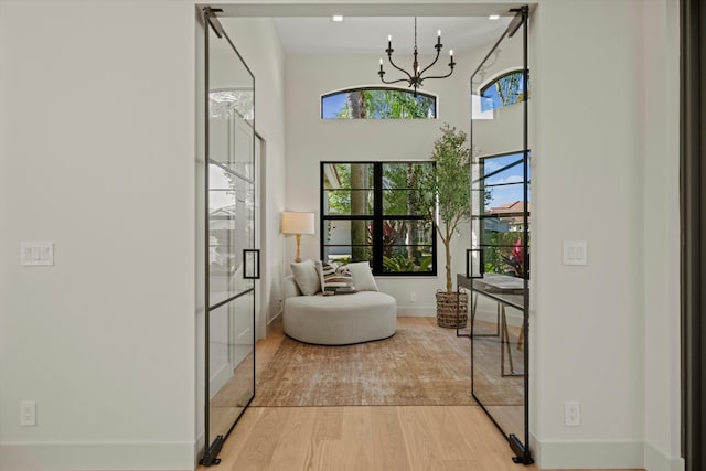 interior space with light hardwood / wood-style flooring and a chandelier