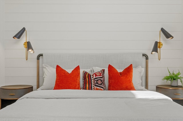 bedroom featuring wood walls