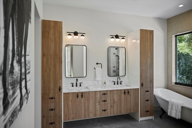 bathroom featuring tile patterned floors, vanity, and a bath