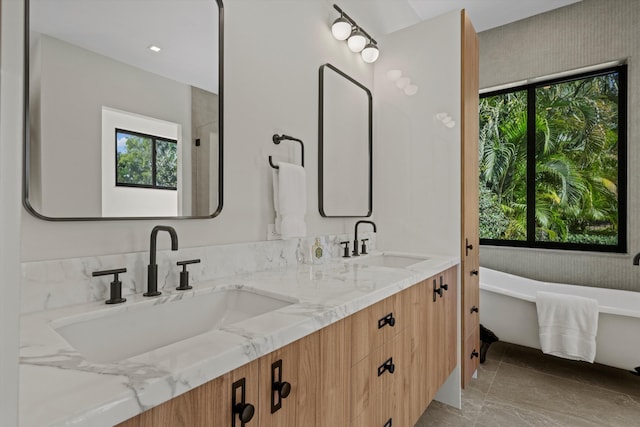 bathroom with a tub and vanity