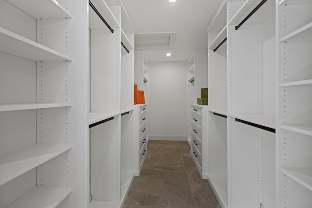 spacious closet with dark tile patterned flooring