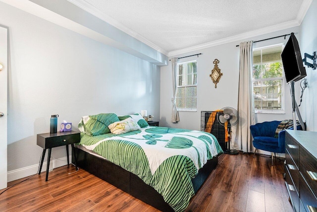 bedroom with a textured ceiling, ornamental molding, and dark wood-type flooring