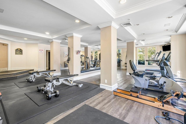 exercise room featuring wood-type flooring and ornamental molding