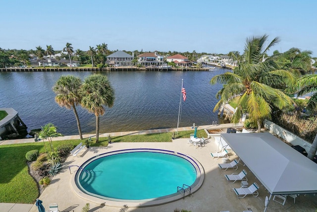 view of swimming pool featuring a water view and a patio