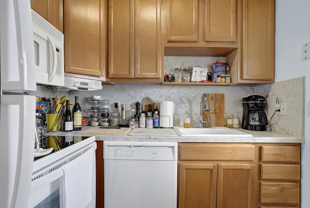 kitchen featuring backsplash, white appliances, and sink