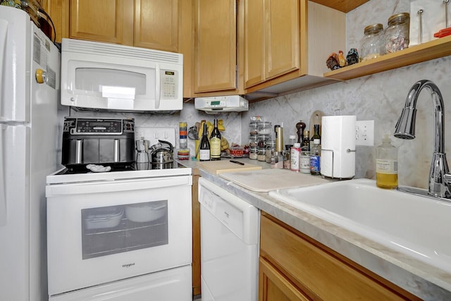 kitchen with decorative backsplash, sink, and white appliances