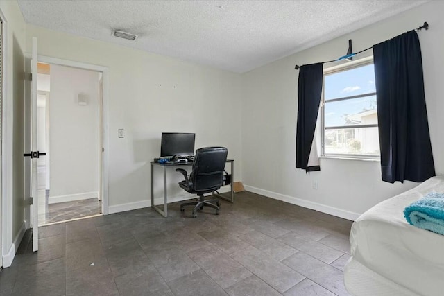 home office featuring visible vents, a textured ceiling, and baseboards