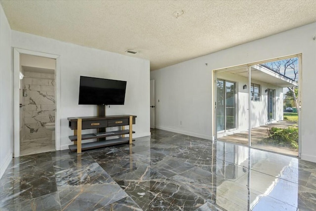 living room featuring a textured ceiling, marble finish floor, visible vents, and baseboards