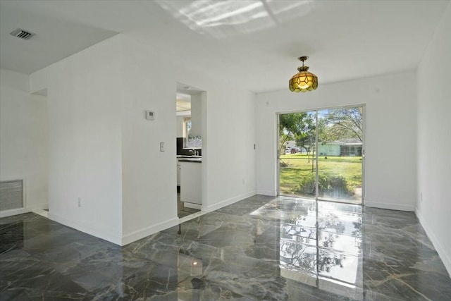 unfurnished dining area featuring marble finish floor, visible vents, and baseboards