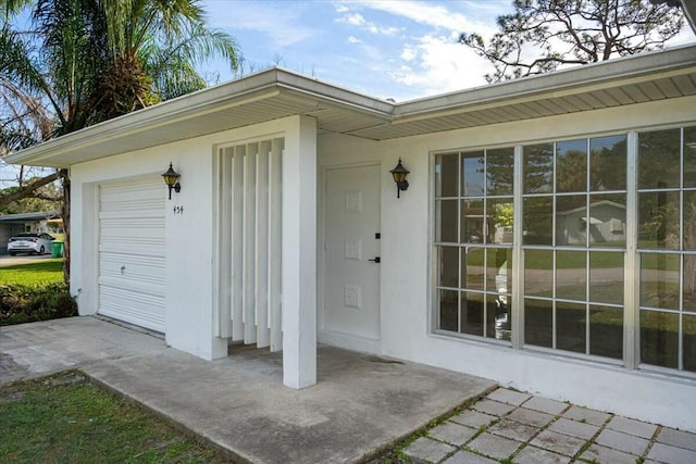 view of exterior entry featuring a garage