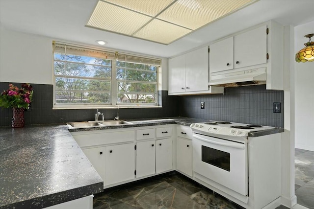 kitchen with dark countertops, white range with electric stovetop, white cabinets, and under cabinet range hood