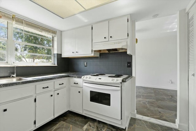 kitchen featuring white range with electric stovetop, marble finish floor, dark countertops, white cabinets, and under cabinet range hood