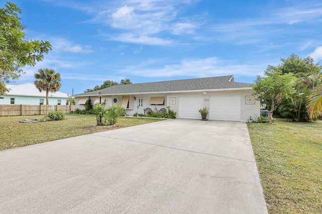 single story home featuring a garage and a front lawn