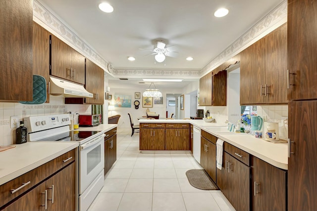 kitchen with white appliances, ceiling fan, light tile patterned floors, tasteful backsplash, and kitchen peninsula