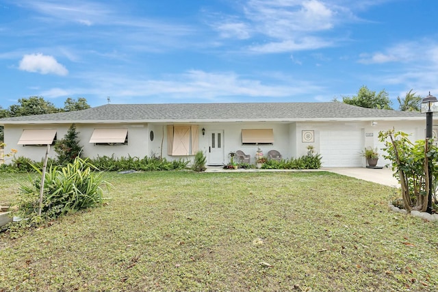 ranch-style house featuring a front yard and a garage