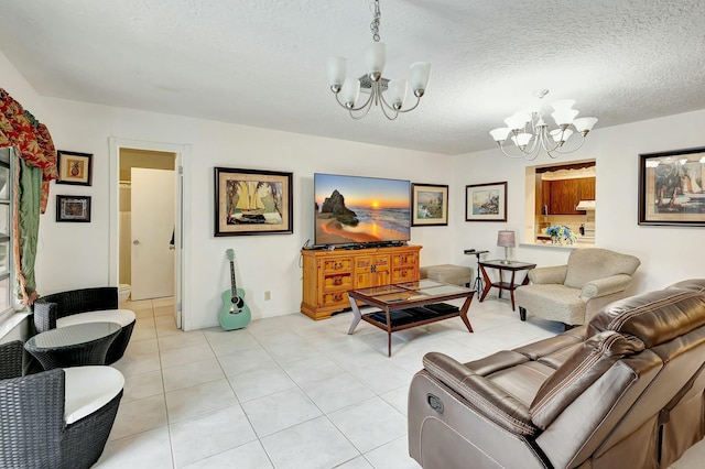 living room with a textured ceiling, a notable chandelier, and light tile patterned flooring