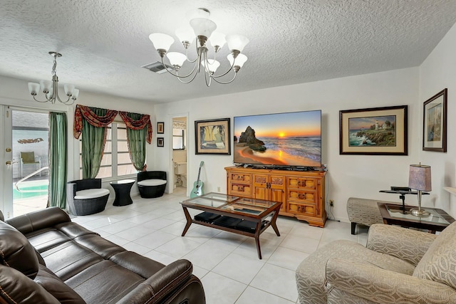 tiled living room with a chandelier and a textured ceiling