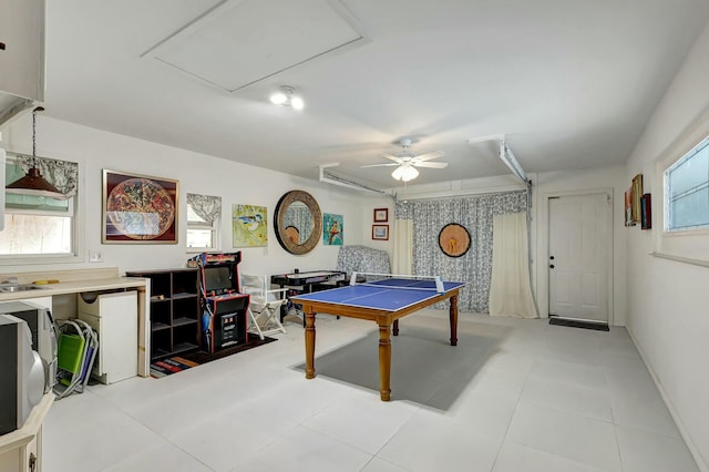 game room with a wealth of natural light, ceiling fan, and light tile patterned floors