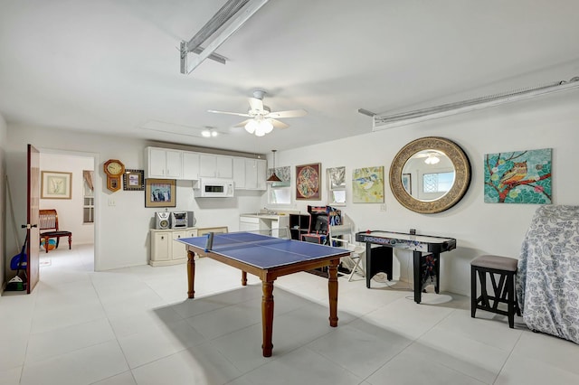 game room featuring light tile patterned floors and ceiling fan