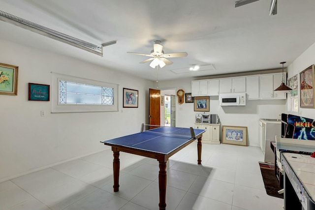 recreation room with light tile patterned floors and ceiling fan