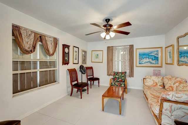 tiled living room with ceiling fan