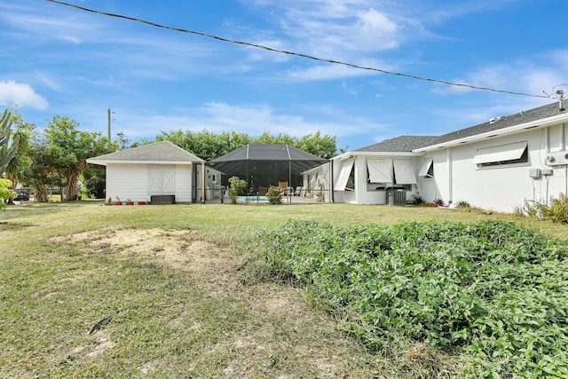 view of yard featuring a lanai and central air condition unit