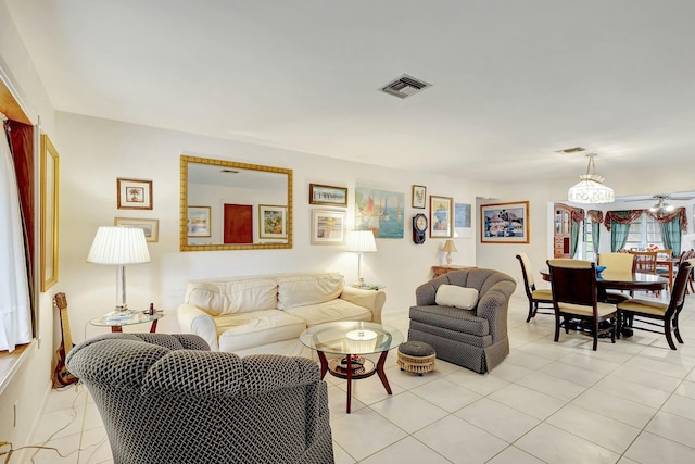 living room with light tile patterned flooring and an inviting chandelier