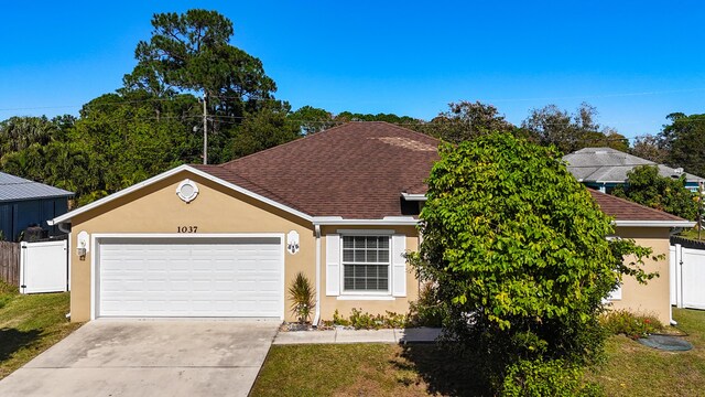 view of front facade featuring cooling unit, a front lawn, and a garage