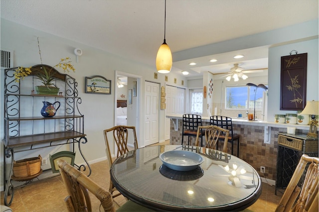 tiled dining area with ceiling fan