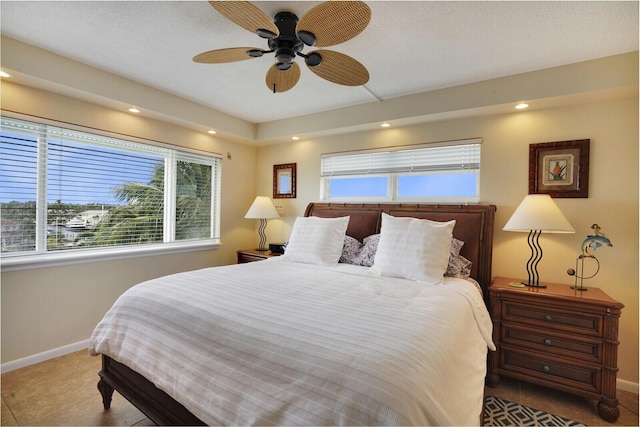 tiled bedroom featuring ceiling fan