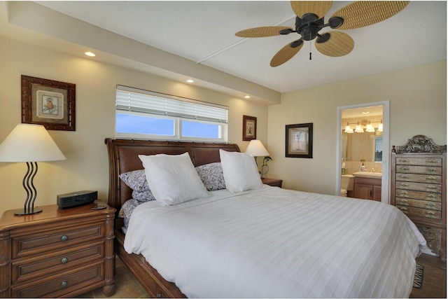 bedroom with ensuite bath and ceiling fan