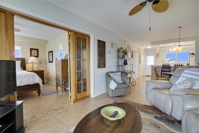 tiled living room featuring plenty of natural light and ceiling fan