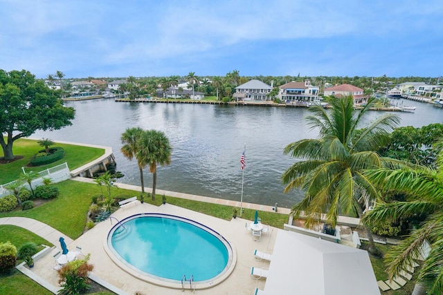 view of swimming pool with a patio area and a water view