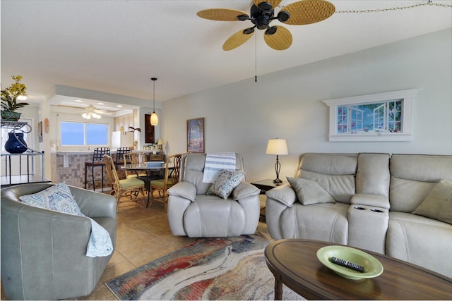 tiled living room with ceiling fan