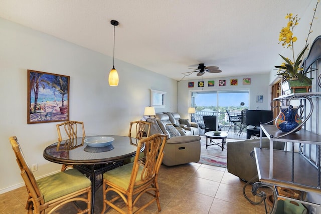 dining space featuring tile patterned flooring and ceiling fan