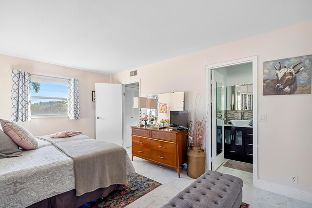 bedroom with ensuite bath and sink