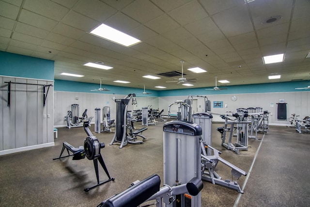 workout area featuring ceiling fan and a drop ceiling