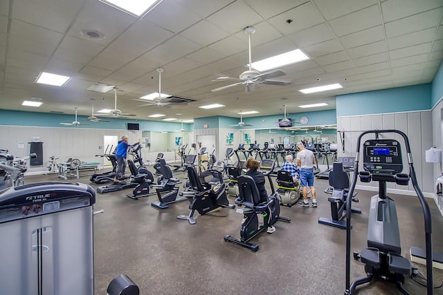 gym featuring ceiling fan and a drop ceiling