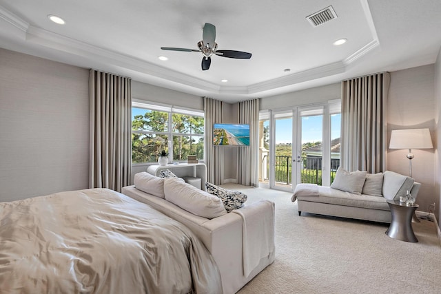 bedroom featuring light colored carpet, visible vents, access to outside, ornamental molding, and a raised ceiling