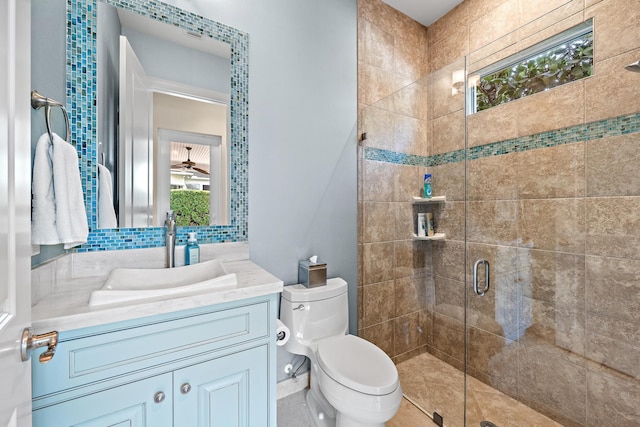 full bath featuring tasteful backsplash, a stall shower, vanity, and toilet