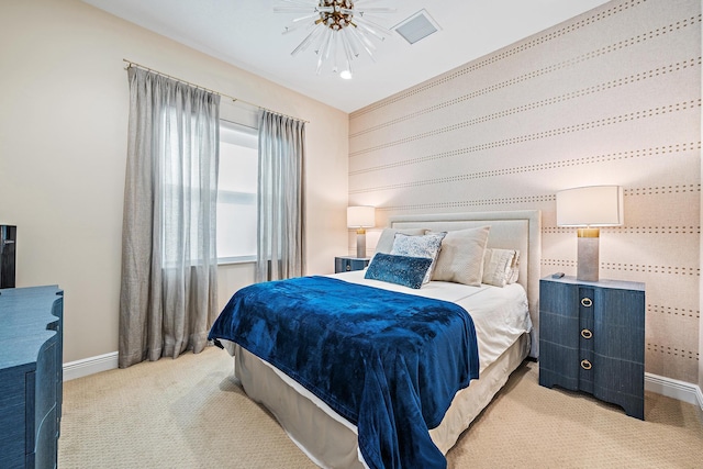 bedroom featuring baseboards, ceiling fan, visible vents, and light colored carpet