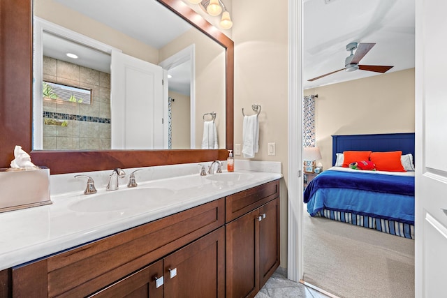 ensuite bathroom featuring ensuite bathroom, double vanity, ceiling fan, and a sink