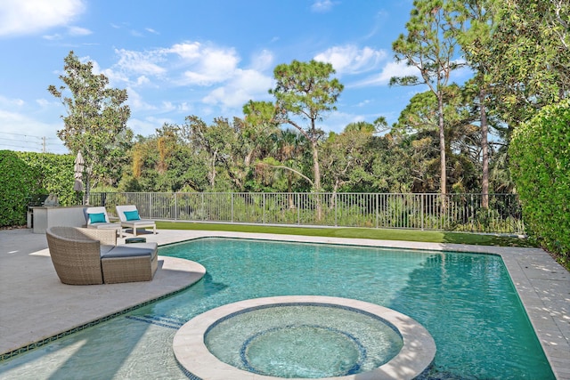 view of pool featuring a patio area, a fenced backyard, and a pool with connected hot tub