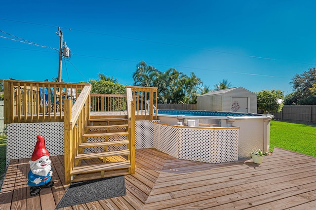 deck with a fenced in pool and a storage shed