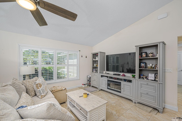 tiled living room with a textured ceiling, a wealth of natural light, ceiling fan, and vaulted ceiling